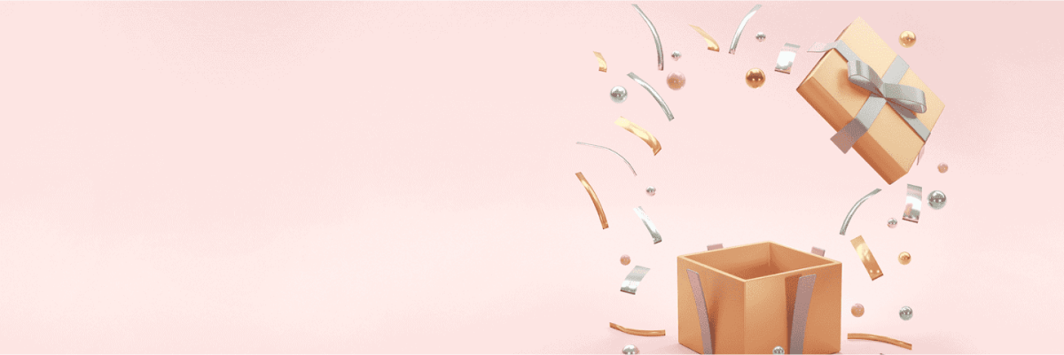 Eine Geschenkbox mit einer silbernen Schleife springt auf und verstreut Bänder und Konfetti auf einem hellrosa Hintergrund.